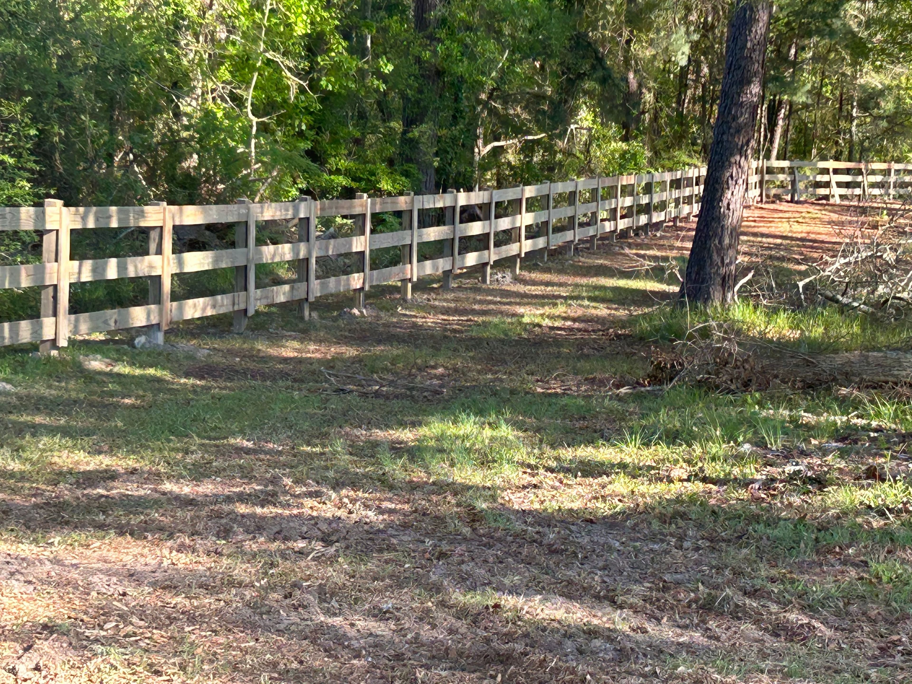 Traditional split rail farm fence outlining a picturesque farm landscape